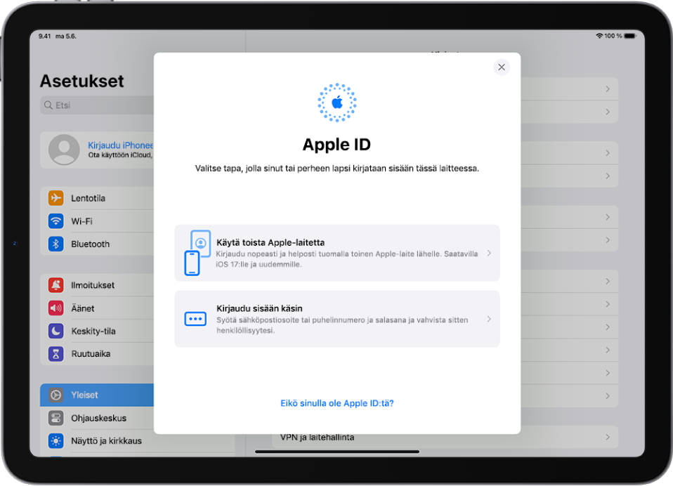 Asetukset-näyttö ja Apple ID -kirjautumisikkuna näytön keskellä.