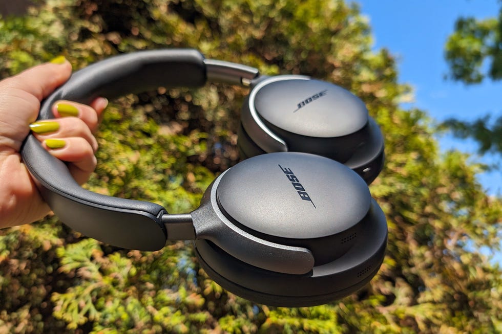 bose quietcomfort ultra headphones held up against blue sky