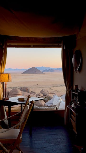 a bedroom with a view of the mountains and the ocean