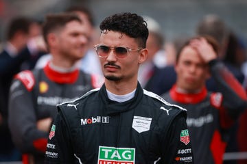 formula e driver pascal wehrlein, wearing his racing overalls and sunglasses, looks thoughtful as he waits on the grid before an eprix