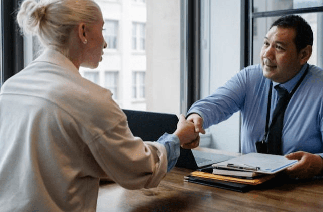 professional people shaking hands across a desk