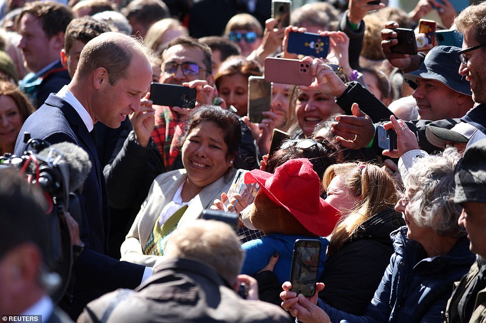 William, Prince of Wales greets people queueing to pay their respects to the late Queen