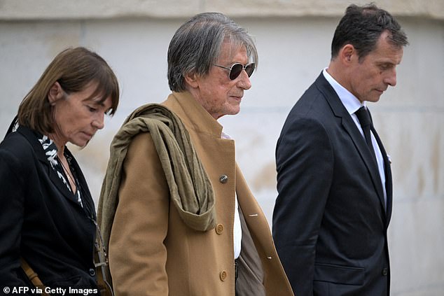 French singer and composer Jacques Dutronc (centre) and partner Sylvie Duval (left) leave after attending the funeral ceremony of the late French singer Francoise Hardy at the Pere Lachaise cemetery, in Paris, on June 20, 2024