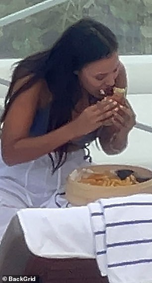 She delightedly tucked into the tasty meal while chilling by the pool