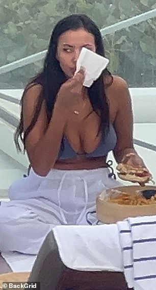 Maya wiped her mouth with a napkin after taking a huge bite of her burger