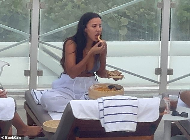 Maya looked in her own world while thoroughly enjoying her food