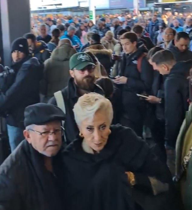 Passengers outside Gatwick's south terminal after a suspected prohibited item was discovered in luggage