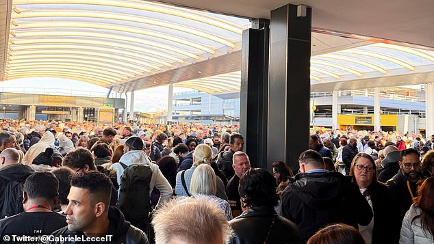 Passengers outside Gatwick's South Terminal after the evacuation on Friday morning at around 10.30am