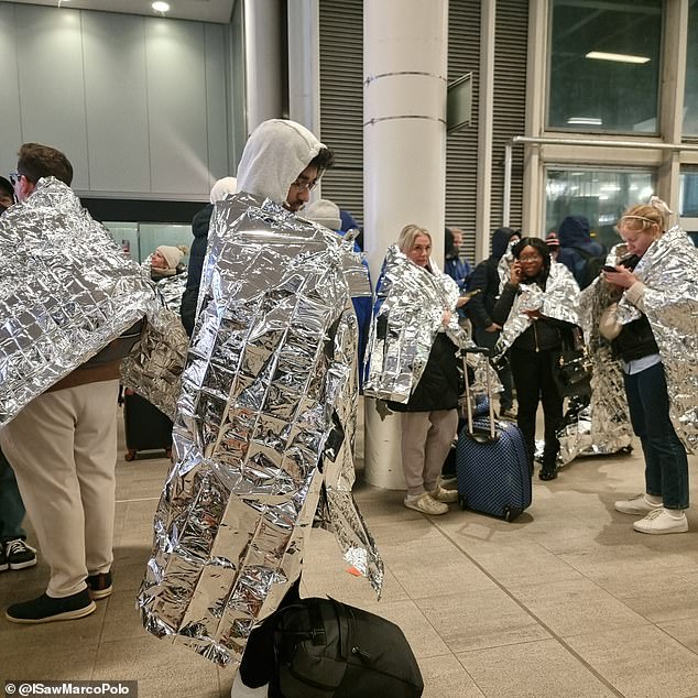 Passengers were seen wrapped up in foil blankets handed out by Gatwick staff as they waited out the security alert in the cold