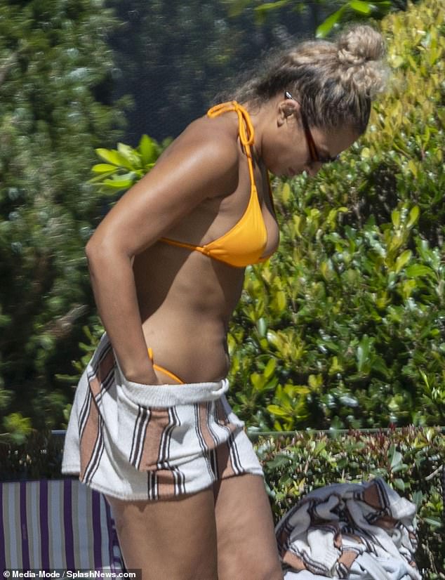 Sam was joined by the pool by ITV2 co-stars Joel Dommett and Kemi Rogers (pictured) who also stripped down to their swimwear to relax in the sun