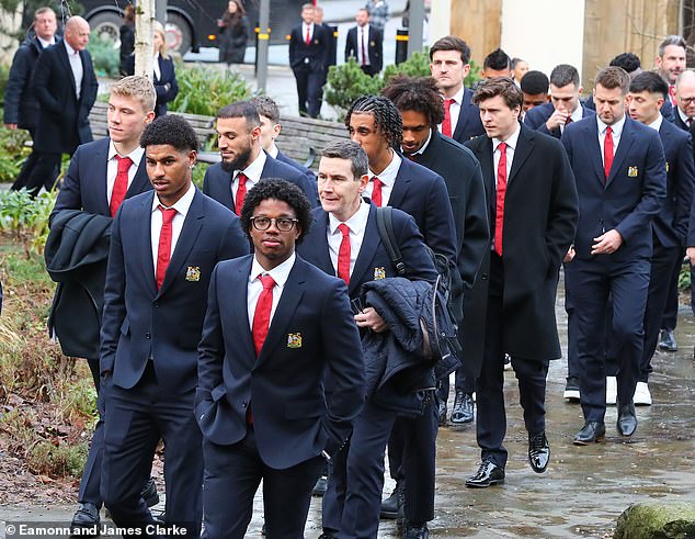 Manchester United players including Marcus Rashford (second left) wore club suits