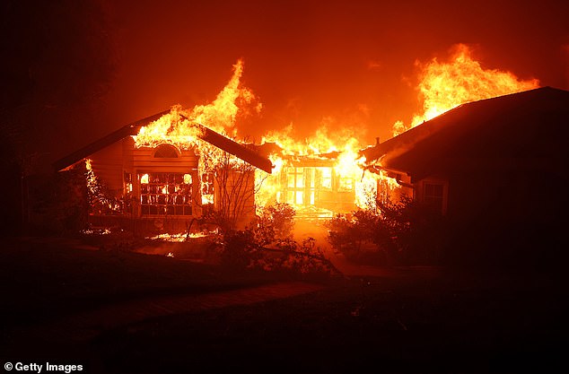 Fire engulfs a home as the Eaton Fire moves through the area on Wednesday fueled by intense Santa Ana winds