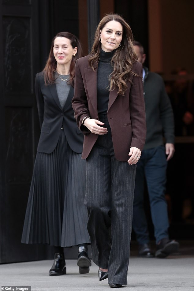 The royal nailed sophiscated chic in pinstripe trousers and a roll neck jumper