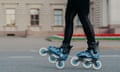 The legs of a woman in blue skates