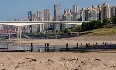 People walk on a dried-out riverbed