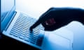 A woman's hand pressing the keys of a laptop keyboard