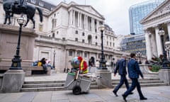 In London, a street sweeper goes about his work near the Bank of England