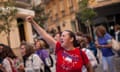 A protester raises her fist during a demonstration against violence against women