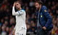 Jordan Henderson stands beside Gareth Southgate.