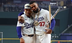 Teoscar Hernández poses with the trophy and third base coach Dino Ebel after winning the Home Run Derby