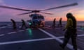 Australian Defence Force Seahawk helicopter prepares to take off from the deck of HMAS Hobart