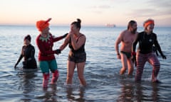 Swimmers in the sea on Boscombe beach in Dorset.