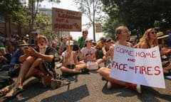 Protesters holding placards demand climate action outside Kirribilli House in Sydney on Thursday