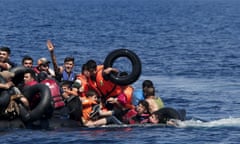 Syrian and Afghan refugees fall into the sea after their dinghy deflated some 100m away before reaching the Greek island of Lesbos, September 13, 2015. Of the record total of 432,761 refugees and migrants making the perilous journey across the Mediterranean to Europe so far this year, an estimated 309,000 people had arrived by sea in Greece, the International Organization for Migration (IMO) said on Friday. About half of those crossing the Mediterranean are Syrians fleeing civil war, according to the United Nations refugee agency. REUTERS/Alkis Konstantinidis      TPX IMAGES OF THE DAY