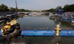 Competitors dive into the Seine at the start of the men's triathlon.