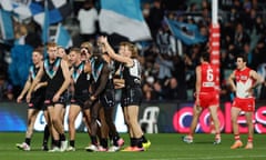 Port Adelaide celebrate while thumping ladder leaders Sydney in their AFL match