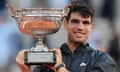 Carlos Alcaraz with the French Open men’s trophy after his victory over Alexander Zverev at Roland Garros, where he will return for the Olympics