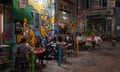 Customers drink outside a bar at night in the Le Cours Julien district in Marseille, France