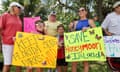 a group of people hold signs that read 'keep Florida state parks wild' and 'save Honeymoon Island'