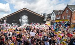 People taking the knee in front of a mural of Manchester United player Marcus Rashford  in Withington, Manchester, July 2021.