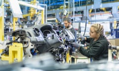 An apprentice engineer on the production line in car factory.