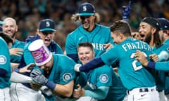 Mariners catcher Cal Raleigh celebrates with his teammates after hitting a walk-off home run against the Athletics on Friday night at T-Mobile Park in Seattle.