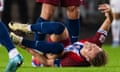 Martin Ødegaard grabs his left ankle after going down injured against Austria.