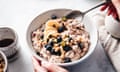 A bowl of oats, milk, bananas and blueberries