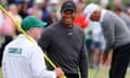 Tiger Woods and the Fred Couples’ caddie on the green on the 9th hole during a Masters practice round