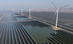 Wind turbines dot the coastline along a giant solar farm near Weifang in eastern China's Shandong province