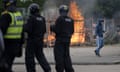 Riot police officers push back far-right protesters outside a Holiday Inn Express hotel housing asylum seekers in Rotherham.