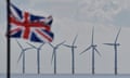 Gunfleet Sands offshore wind farm turbines can be seen as a Union Jack flag flies on September 29, 2022 in Clacton-On-Sea, England. 