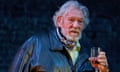 ian mckellen in a leather jacket holding a drink, as falstaff