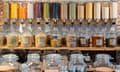 Rows of glass jars and dispensers filled with different foods