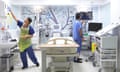 Doctor and Nurse preparing a hospital bed on a private ward in the UK.FY0H4A Doctor and Nurse preparing a hospital bed on a private ward in the UK.