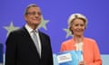 Mario Draghi and Ursula von der Leyen standing alongside each other and smiling at a press call in Brussels; she is holding a copy of the report