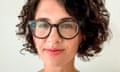 Young-ish white woman with curly brown hair and tortoiseshell glasses wearing white blouse.