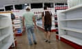 Two men looks for goods in a supermarket amid empty shelves in the Petare district of Caracas on Thursday.