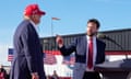 JD Vance and Donald Trump standing near a podium during a rally.