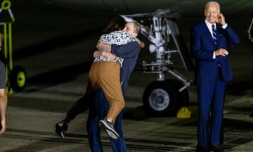 President Joe Biden looks on as Evan Gershkovich, released from detention in Russia, is greeted by his mother Ella Milman.